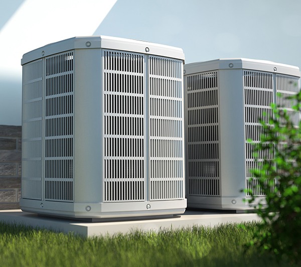 two_hvac_units_side_by_side_in_grass