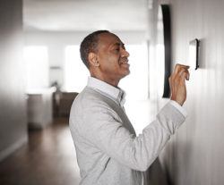 Manhattan Beach homeowner using a smart thermostat to control his Daikin mini split ac system Heating service in Manhattan Beach